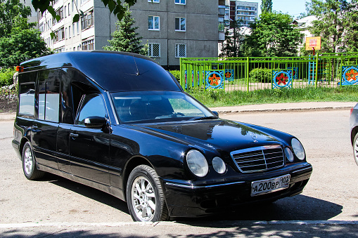 Ufa, Russia - May 17, 2012: Black hearse car Mercedes-Benz W210 E-class is parked in the city street.