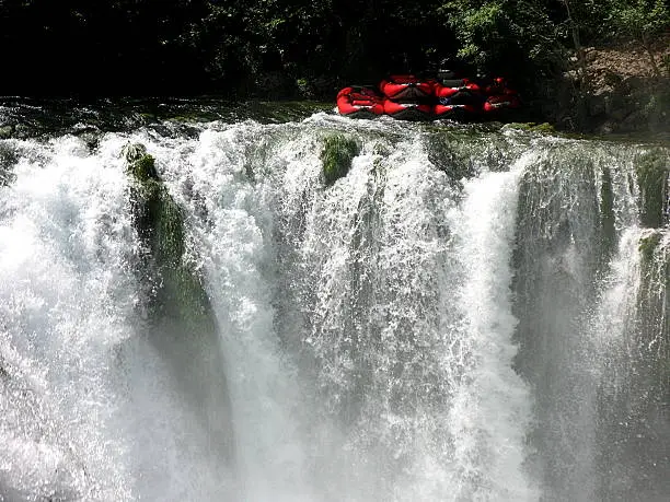 Rafting boats on the top of waterfall.
