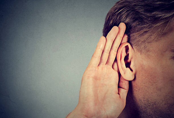 istock man holds hand near ear and listens carefully 590285014