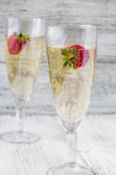 istock two champagne glasses and strawberries 590285100