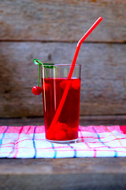 istock Glass of red cherry compot 590285252