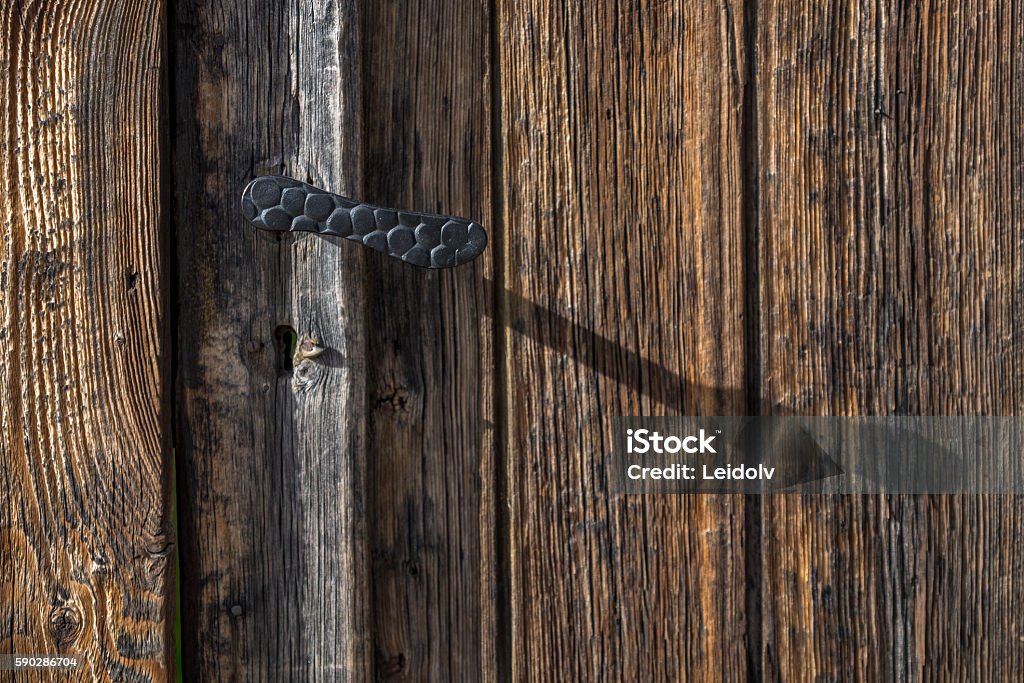 Door handle Wooden door in Røros, Unesco mining town.  Aging Process Stock Photo