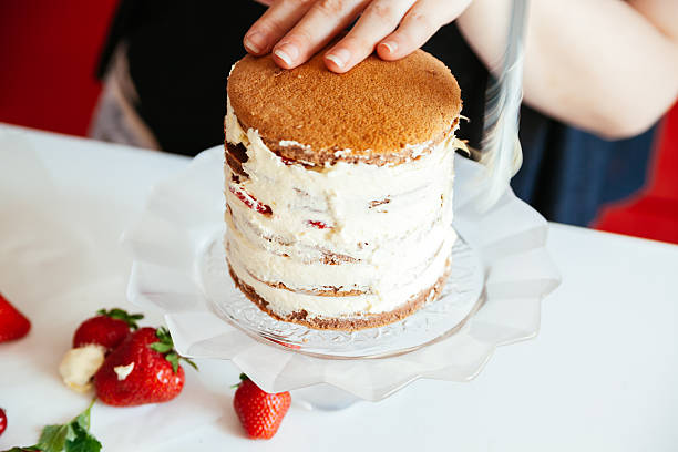 istock Woman Making The Naked Cake 590288038