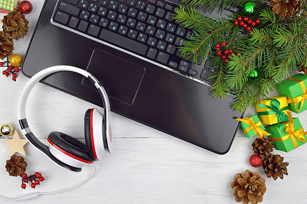 istock Headphones, computer and Christmas tinsel. Holiday melodies. 590291228