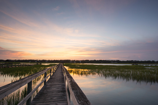 boardwalk on the marsh in Pawleys Island, South Carolina at sunset