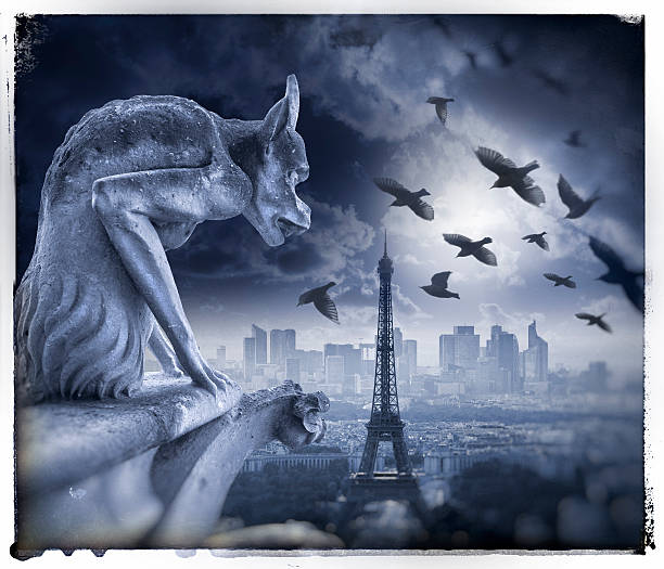 istock Gargoyle figur on Notre Dame with Eiffel Tower at night 590293310