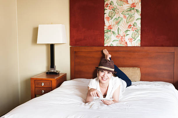 istock Woman to operate the tablet on the bed 590293878