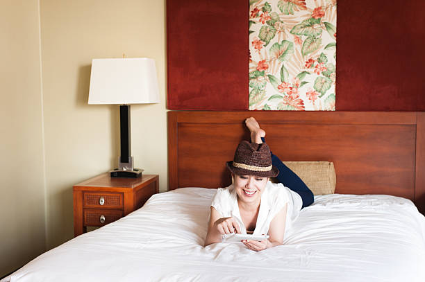 istock Woman to operate the tablet on the bed 590294004