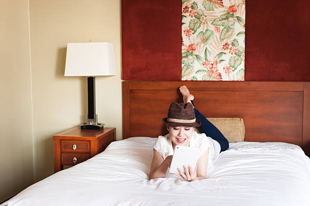 istock Woman to operate the tablet on the bed 590294140