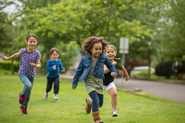Young diverse girls playing together in the neighborhood park
