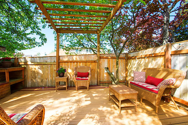 istock Backyard deck with wicker furniture and pergola. 590295004