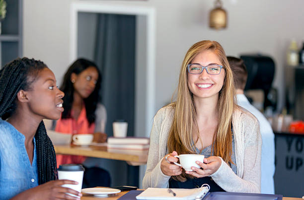 istock Young attractive diverse female friends in a coffee 590295052