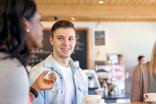istock Young caucasian male talking with friends 590295116