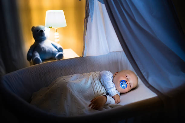 istock Adorable baby boy sleeping at night 590295472