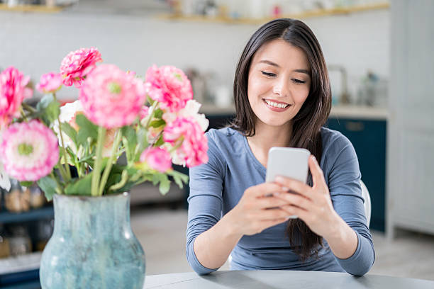istock Woman at home texting on her phone 590295692