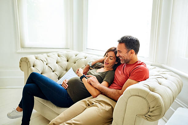istock Pregnant couple playing with a smart watch 590296216