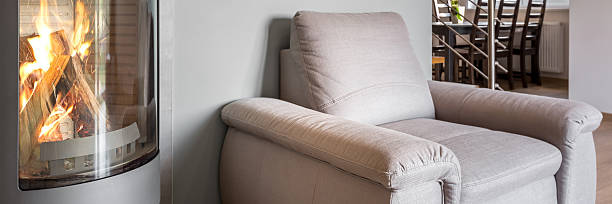istock Simple armchair next to fireplace 590296310