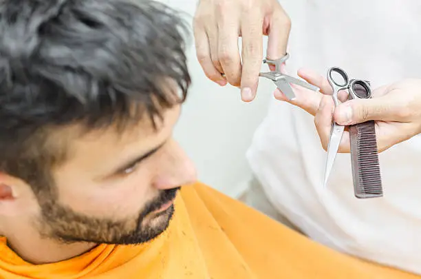 Photo of Hairdresser preparing for work and selects the appropriate tool