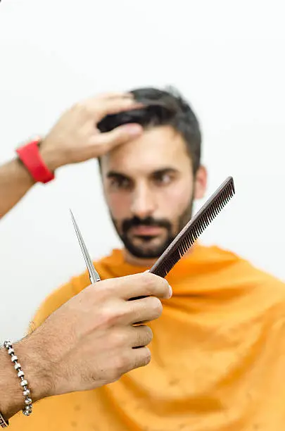 Photo of Hairdresser preparing for work and selects the appropriate tool