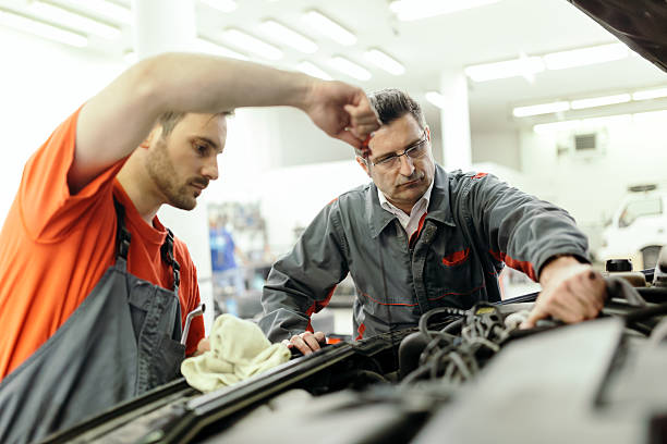 istock Car mechanic upkeeping car 590297658