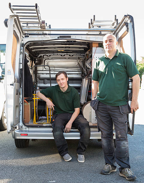 istock Two aerial communication engineers at back of their van. 590298256