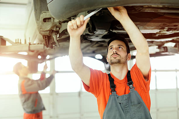 istock Car mechanic upkeeping car 590298292