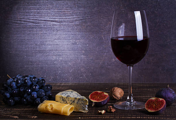istock Red wine glass with fruits, cheese, figs and nuts 590298608