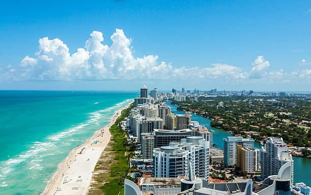 South Beach From Above Looking down South Beach in Miami. Full view of the beach on the left and the city on the right. Beautiful blue sky on a clear day.  coastline stock pictures, royalty-free photos & images