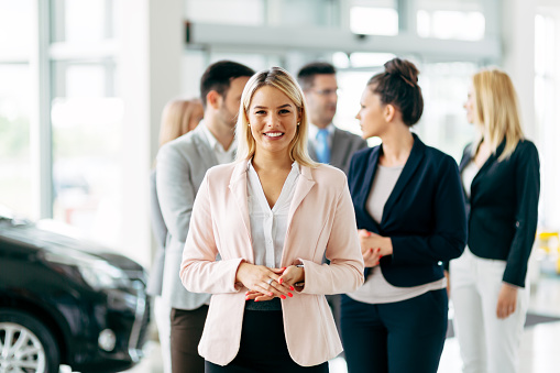 Team of professional salespeople at car dealership