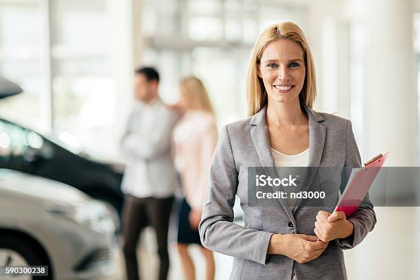 Salesperson Working At Car Dealership Stock Photo - Download Image Now - Car, Car Salesperson, Selling