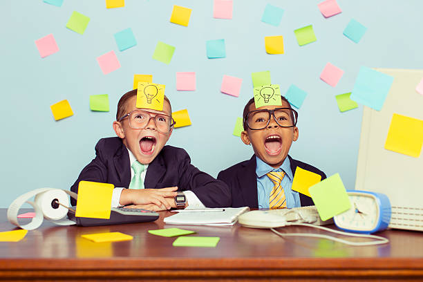 istock Two Young Businessmen at Desk Covered with Sticky Notes 590300998