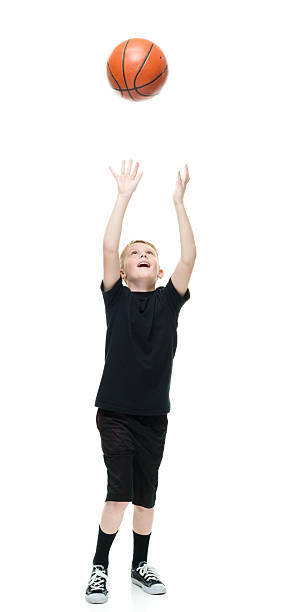istock Smiling male playing with basketball 590304042