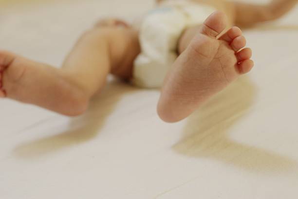 istock Baby little feet 590305888