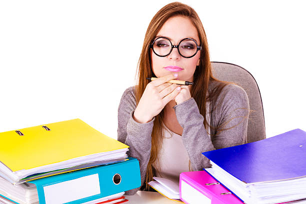 istock Woman sitting at desk in office and thinking 590579724