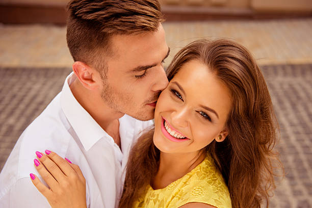 istock handsome young man kissing his beloved's cheek 590581502