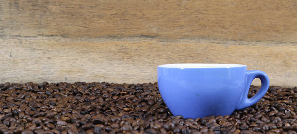 istock Coffee mugs and coffee beans on a wood floor. 590583832