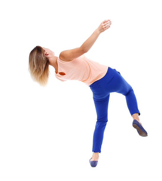 Balancing young woman. Balancing young woman. or dodge falling woman. Rear view people collection. backside view of person. Isolated over white background. The blonde in a pink t-shirt in freefall vista posterior stock pictures, royalty-free photos & images