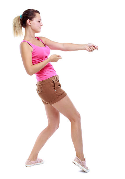 istock back view of standing girl pulling a rope from the 590587620