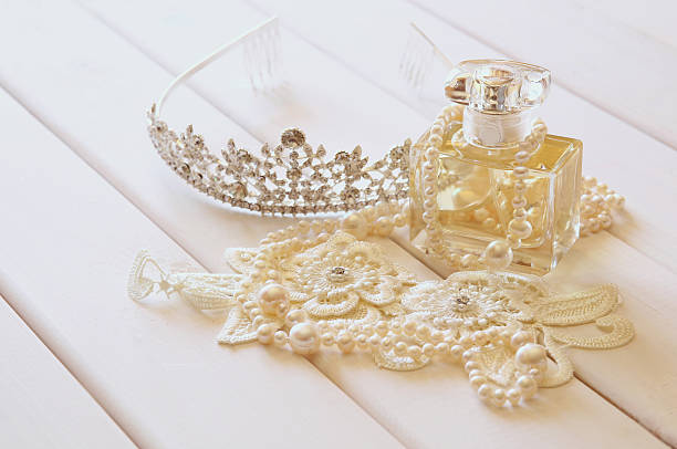 istock White pearls necklace, diamond tiara and perfume bottle 590588200