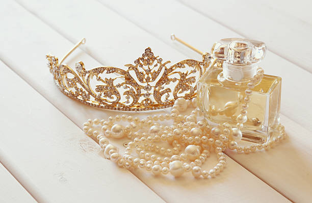 istock White pearls necklace, diamond tiara and perfume bottle 590588236