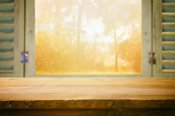 istock table in front of blurry autumn nature through the window 590589070