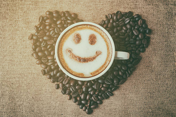 istock coffee with foam milk art smile pattern in heart shape 590590138