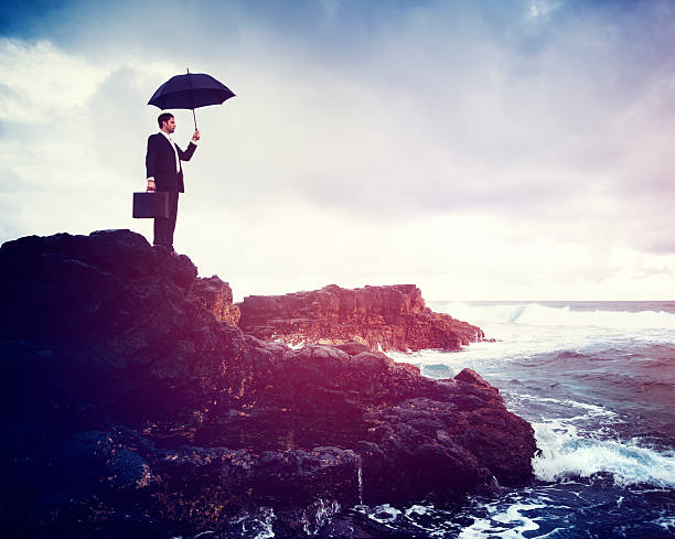istock Lonely Businessman Standing by the Beach Concept 590590288