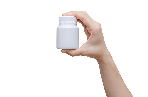 istock hands holding medicine bottle on white background 590591184