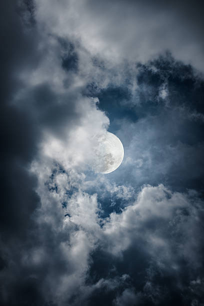 istock Attractive of a nighttime sky with clouds, bright moon. Outdoor. 590591292