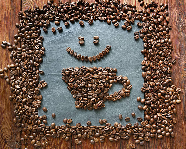 istock Smiley face from coffee beans at stone background 590592132