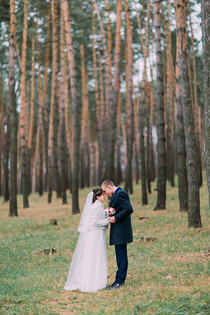 istock Happy newlywed pair have romantic walking in the young pine 590592698