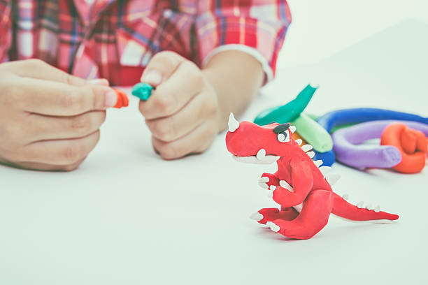 istock Asian child show his works from clay, on white background. 590593180