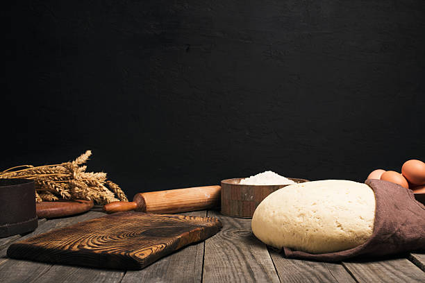istock Yeast dough, flour, eggs, wheat and rolling pin 590593646