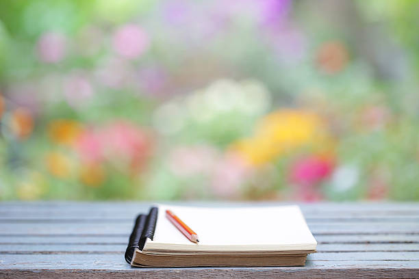 istock Notebook and pencil on wooden table 590593752